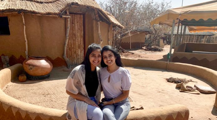 Alumna taught life skills in Botswana as Peace Corps volunteer Two women sit on a ledge