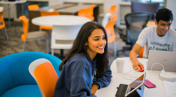 Don’t let criticism overshadow praise | Ask Kelly student looks up from studying on an ipad