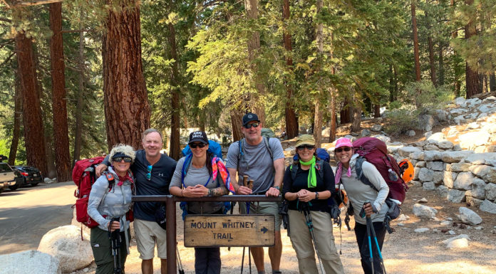 Mercer alumni climb Mount Whitney, the highest mountain in contiguous U.S. A group of six people pose for a picture at the Mount Whitney Trail sign