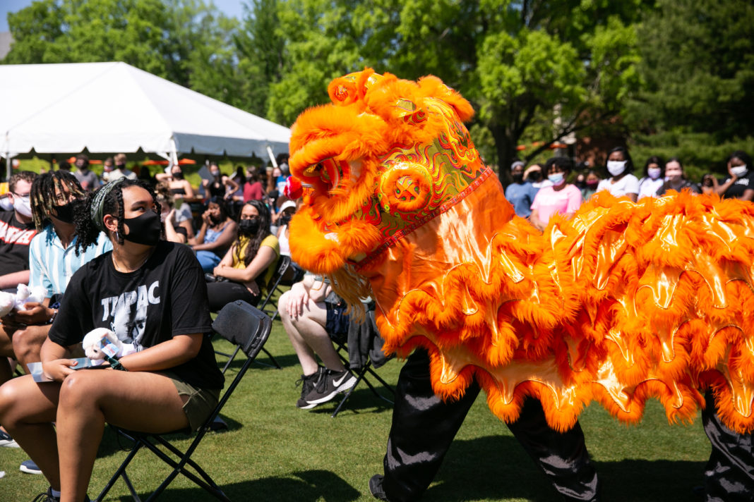 a traditional chinese lion dance is performed on cruz plaza