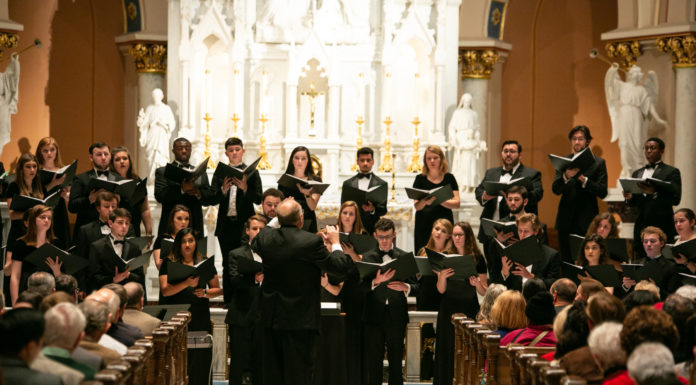 Beloved tradition returns with 26th annual Festival of Nine Lessons and Carols A conductor leads a choir in front of a church