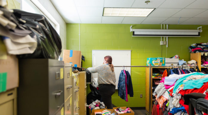 Students help homeless by volunteering at Brookdale Resource Center Lara Edgeman, a junior majoring in education, moves clothes at the Brookdale Resource Center in Macon on Dec. 3.