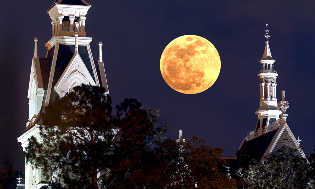 The moon between the Administration Building's spires