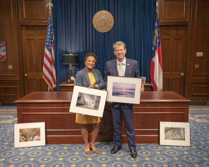 Cynthia Robertson is pictured with Gov. Brian Kemp and her artwork.