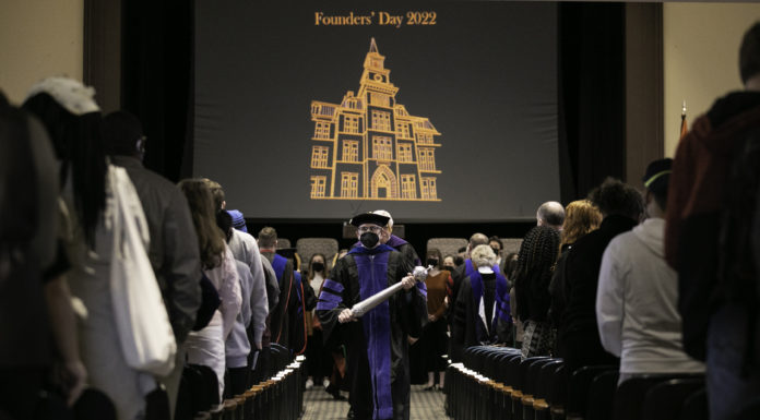 The history and traditions behind Mercer’s university marshals Dr. Tom Scott leads administrators and faculty out of Willingham Auditorium after the Founders' Day 2022 program.