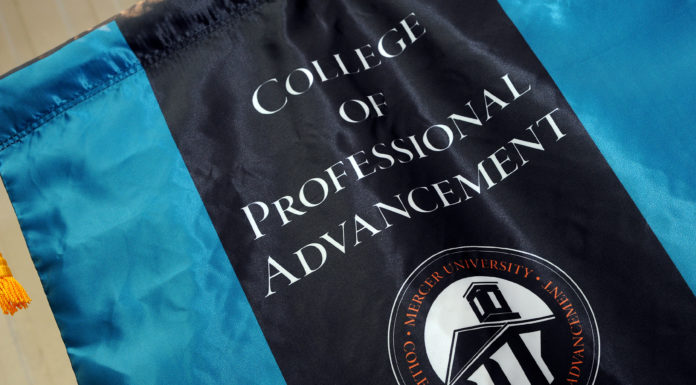 New symposium to explore leadership across private, public and nonprofit sectors A flag with College of Professional Advancement is printed in while letters on black background with blue strips on either side.