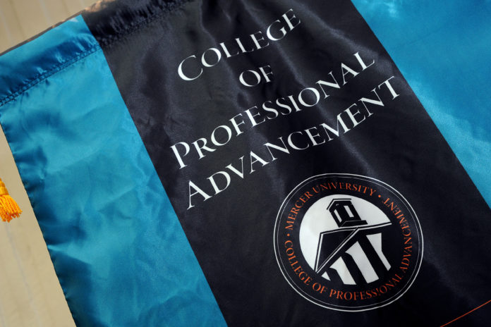 A flag with College of Professional Advancement is printed in while letters on black background with blue strips on either side.