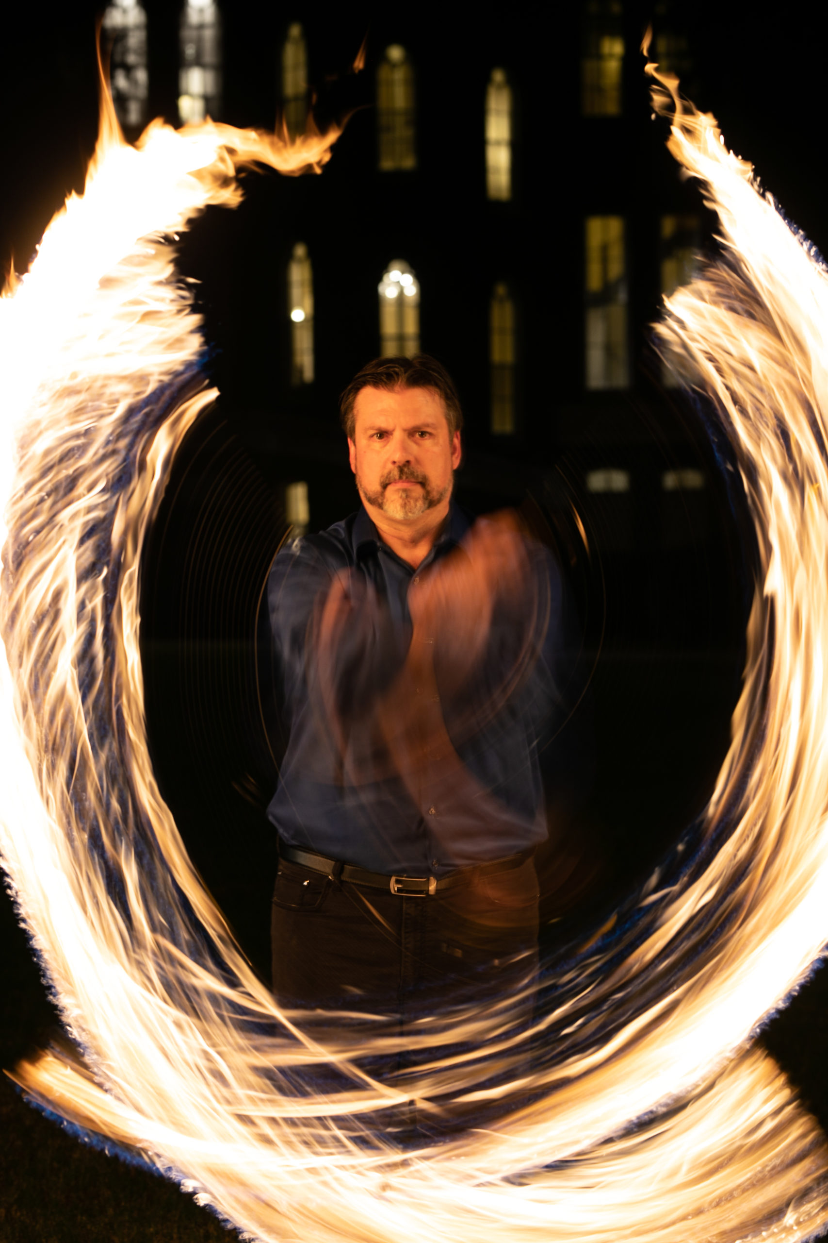 Scot Mann, director of theater, twirls fire on the Macon campus.