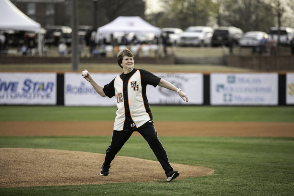 woman throws first pitch at baseball game