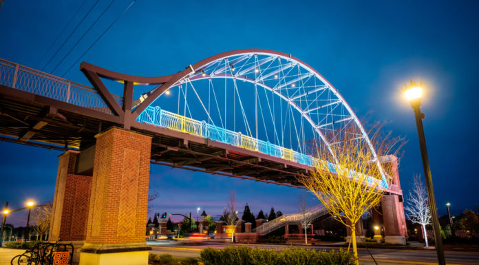 Amid the suffering in the world, it is up to us to share bridge is lighted blue and yellow