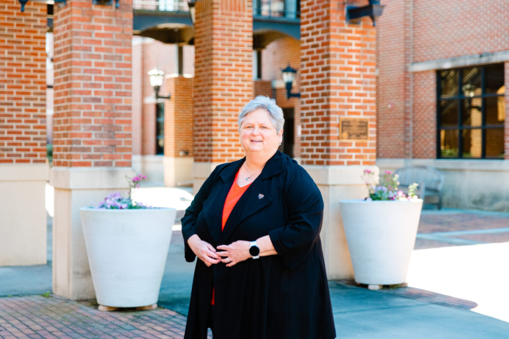 Dr. Laura Lackey stands in front of the Engineering Building at Mercer University