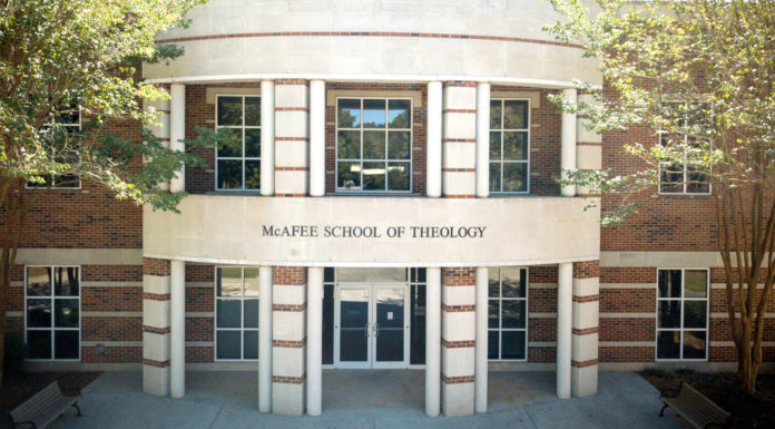 Weekly virtual meditations connect, center Mercerians Front entrance of McAfee School of Theology with brick facade, glass doors, and surrounding trees.