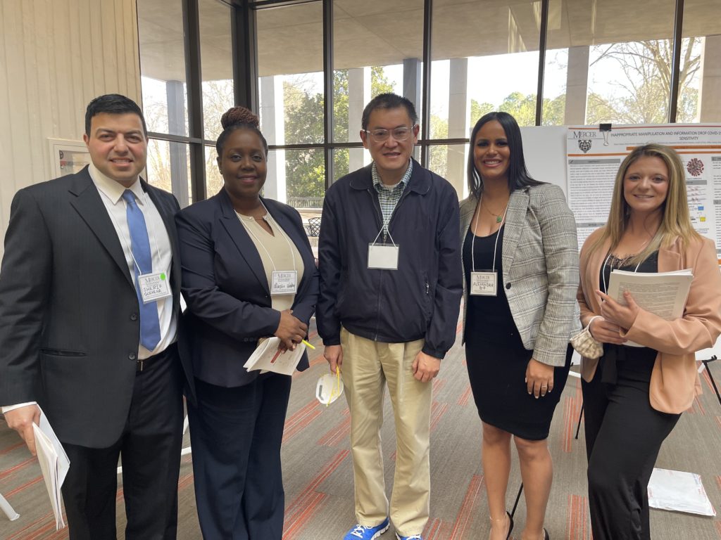 Dr. Jia Fei, center, is and some of his biology students are pictured at the Atlanta Research Conference on March 26, 2022.