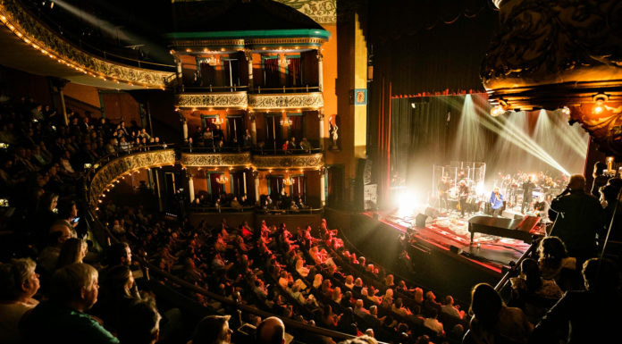 Students get unparalleled opportunities in the spotlight | Arts at Mercer A stage of performers is photographed from the balcony