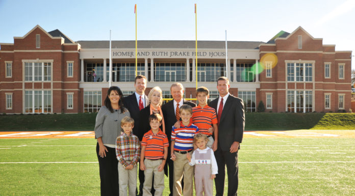 Mercer Life Trustee a significant contributor to the University and bankruptcy law A family stands in front of the Homer and Ruth Drake Field House.