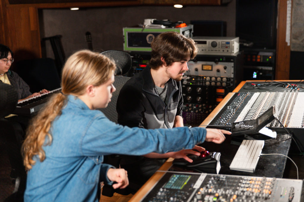 Two men work at a sound board