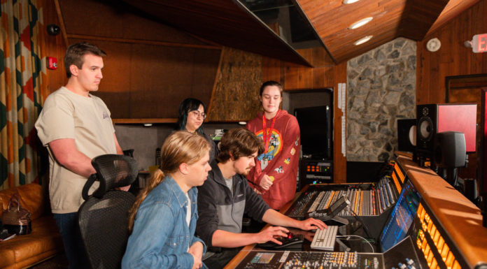 Students get hands-on experience learning at Capricorn Sound Studios | Classroom Spotlight Students sit at a sound board