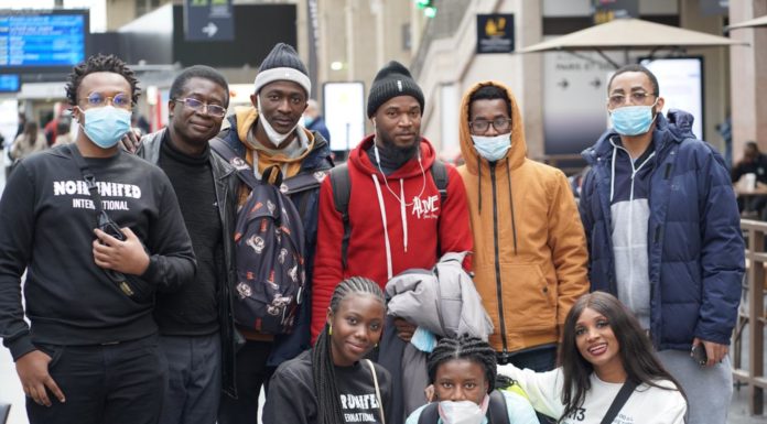 Alumni travel to Europe to help African college students evacuating Ukraine A group of nine people pose for a photo
