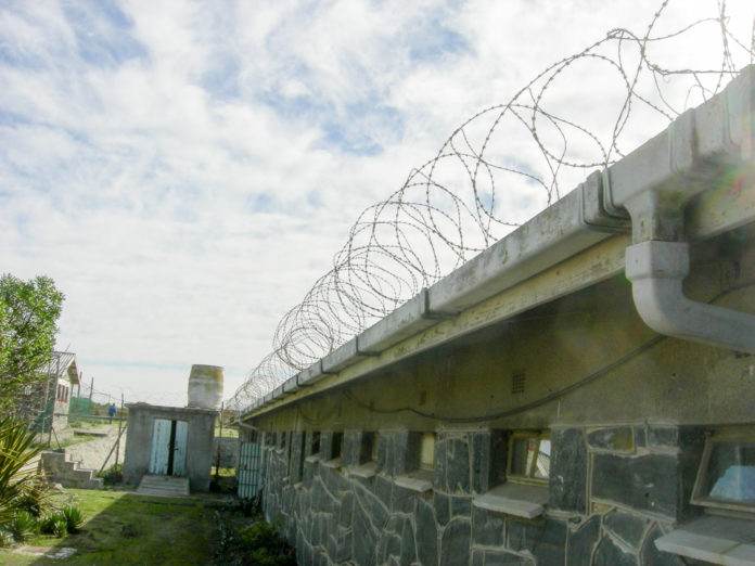 Barbed wire surrounds an old prison