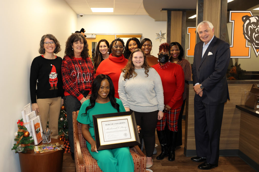 Shoshannah Henry (front) is pictured with Mercer President William Underwood and team members in the Office of Student Financial Planning.