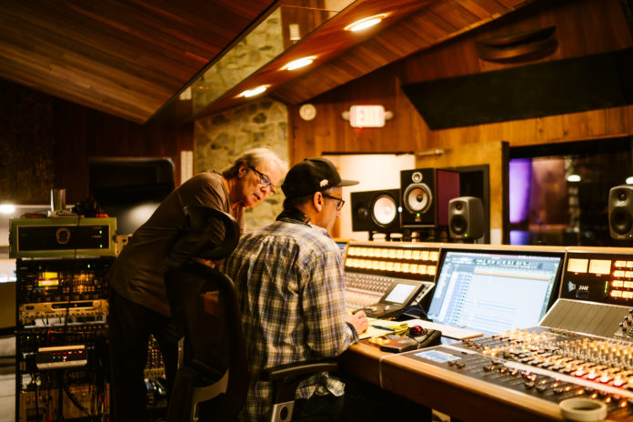 Two man work at a sound console