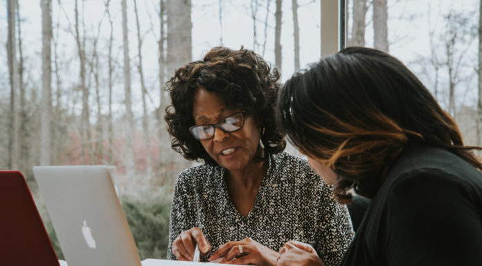 Eliminate self-doubt in your new educational journey | Ask Kelly Two women look at a laptop.