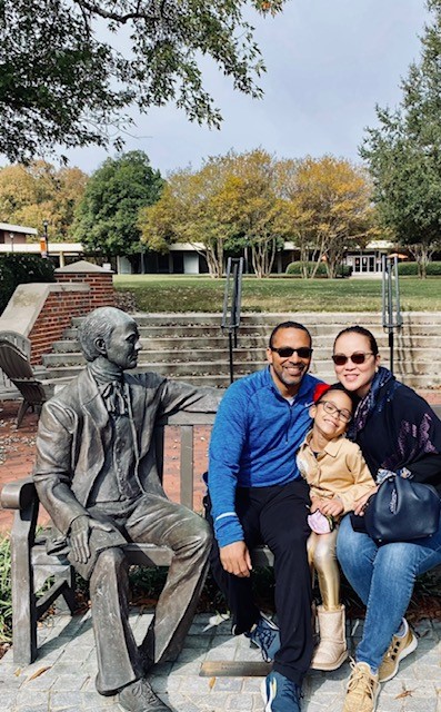 Drs. Ronson and Celeste Hughes and their daughter, Isabelle, by the Jesse Mercer statue.