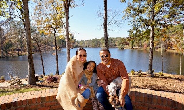Couple tackles MBA program together — and with some friendly competition Drs. Celeste and Ronson Hughes and their daughter, Isabelle, along with their dogs.