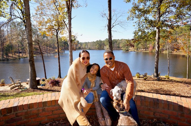 Drs. Celeste and Ronson Hughes and their daughter, Isabelle, along with their dogs.