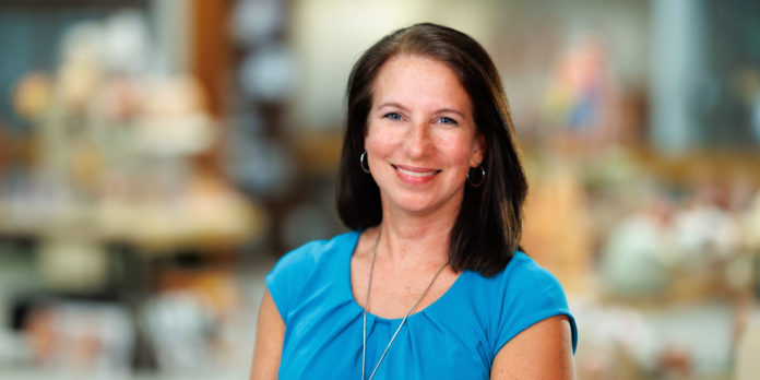 Bridges-Christy-Library-2 Dr. Christy Chancy Bridges smiles at the camera in an indoor setting with a blurred background.