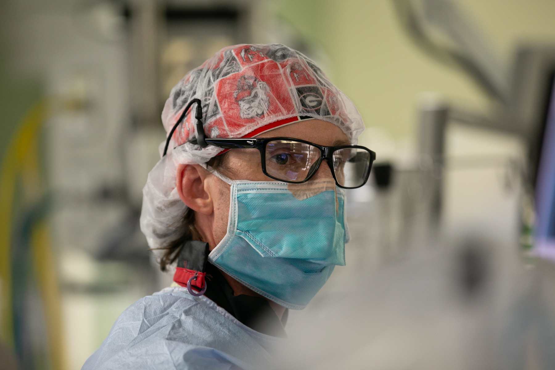 Dr. Allen Ligon wears a hairnet glasses and surgical mask.