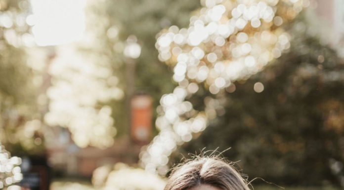 Graduate Spotlight: Natalie Galt A young woman holds out a graduation cap toward the camera