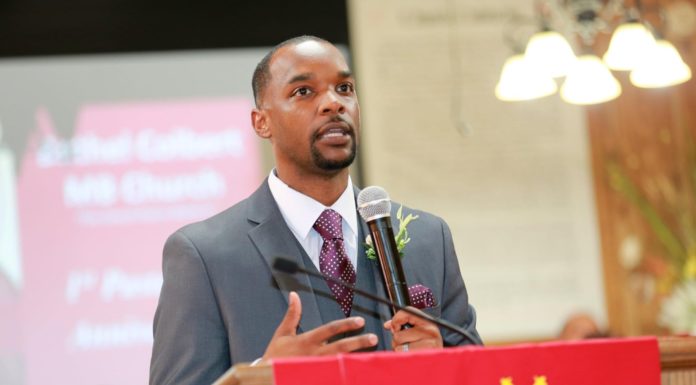 Theology alumnus serves community through pastoral and political work Wesley Thompson preaches at a podium.