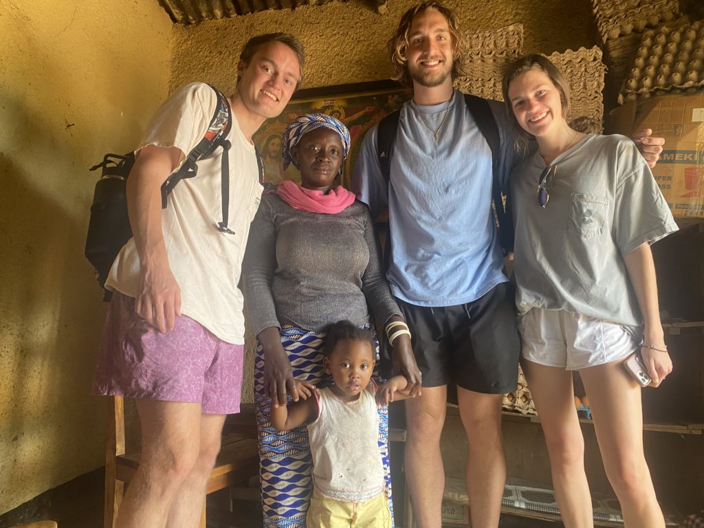Mercer students visit with a Rwandan family. Photo courtesy Layne Davis