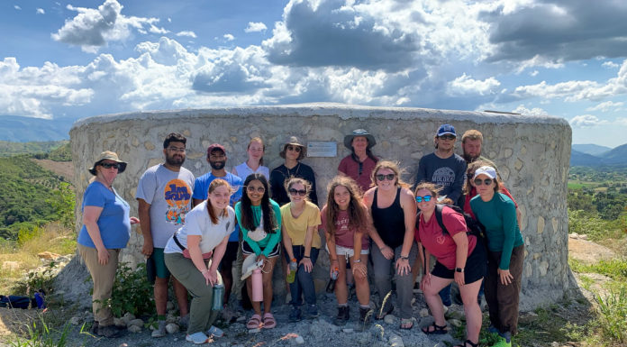 Mercerians bring clean water to underserved communities in Dominican Republic The Mercer group is pictured by one of the water systems that Mercer helped create in the Dominican Republic.