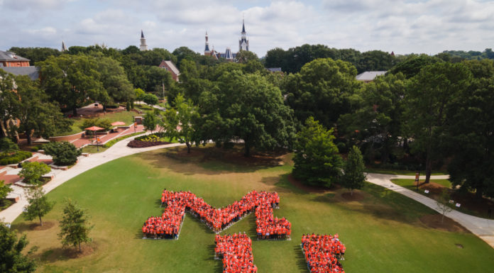 Class of 2022 graduates offer this advice to incoming freshmen Aerial photo fo people standing in the shape of an M and a U