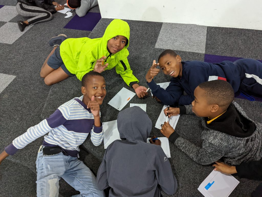 Cape Town children work on a computer science lesson.