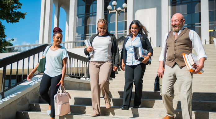 What activities are available to students in Regional Academic Centers? | Ask Kelly Four adults walk down stairs