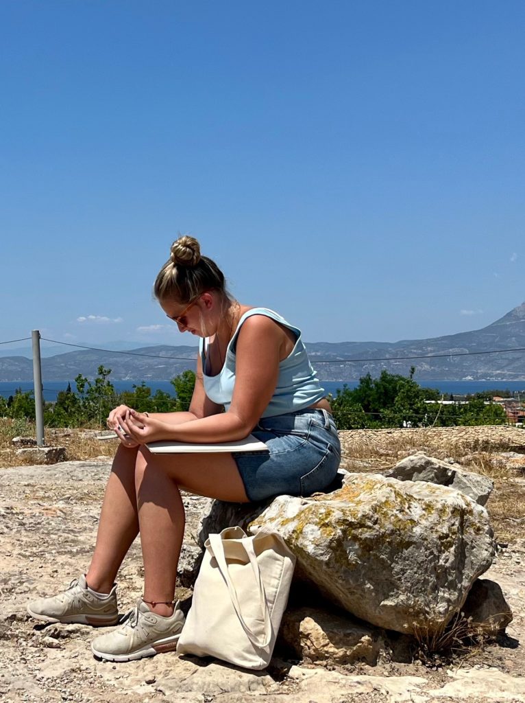 Helen O'Dell sketches at the Temple of Apollo in Corinth. 