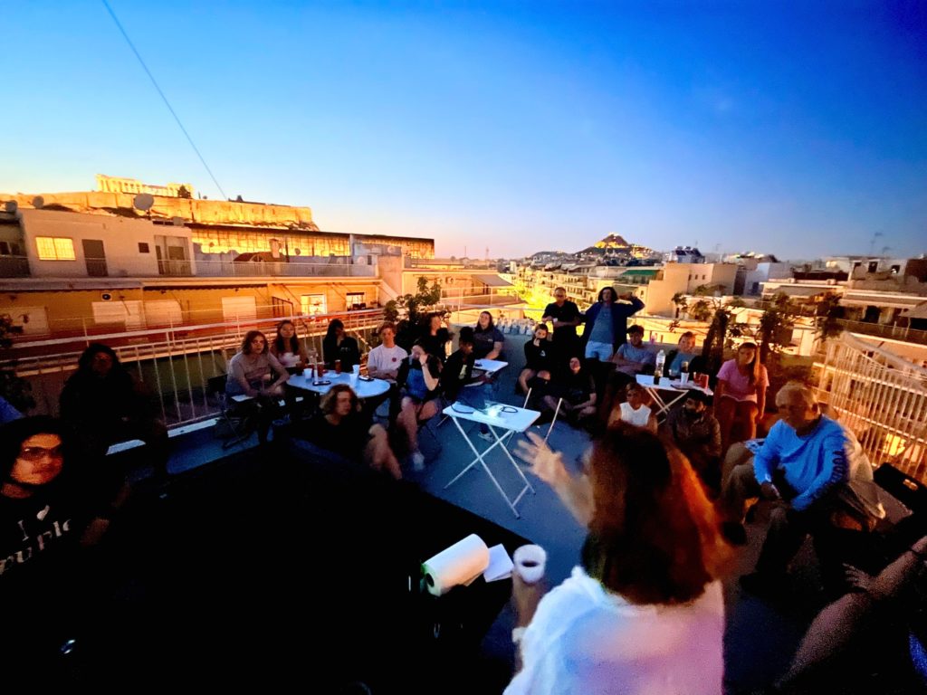 The Mercer group has class on the rooftop of their apartments, with a  view of the Acropolis. 