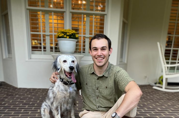 Mercer alumnus Luke Kolbie is pictured with his dog, Vela. Kolbie is wearing his great-grandfather's Russell Moccasin boots. He is the owner of Kingfisher Leatherworks and is now also CEO of Russ Moccasin.