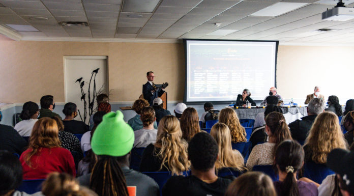 Second annual Gothic Festival celebrates art, literature, film on Macon campus A man stands at the front of a room and speaks into a microphone while a crowd of people watch on