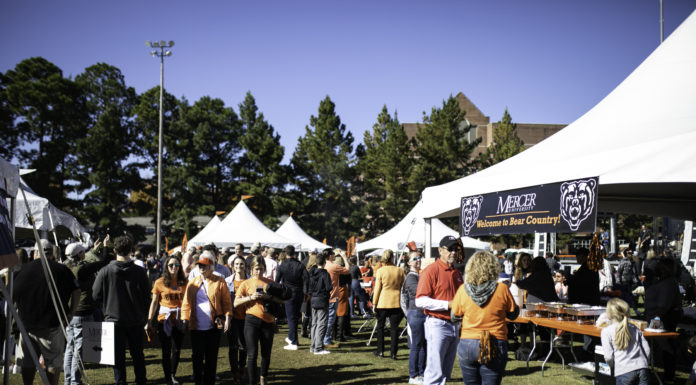 3 ways students can help their career during Homecoming people congregate around white tents for tailgating