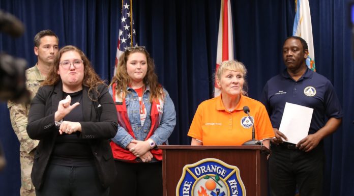 Mercer student helps with Hurricane Ian relief as Red Cross volunteer Mercer student Samantha Cannon (in red vest) is shown at a press briefing in Orange County, Florida, following Hurricane Ian. Speaking is Lauraleigh Avery, Division Chief of Orange County Fire Rescue. Shown at left is a National Guard member and an interpreter and at right is Orange County Mayor Jerry Demings.