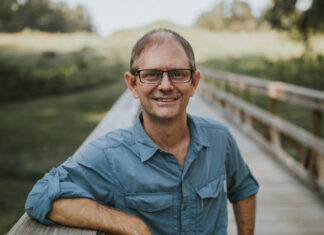 English professor chosen for inaugural Georgia Humanities Georgia Circuit Speakers Bureau Gordon Johnston stands on a boardwalk.