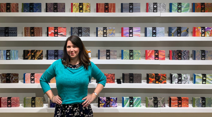 Art you can touch: Mercer professor creates handcrafted book art Tennille Shuster stands in front of the pandemic journals she handcrafted.