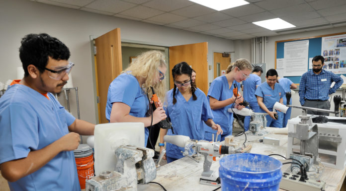 University dedicates Sheridan Mercer On Mission Center benefiting prosthetics program A group of people in scrubs use equipment on prosthetic legs