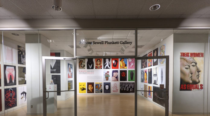 Graphic design exhibit illustrates social justice, human rights issues glass doors open up into an exhibit with colorful poster on the wall