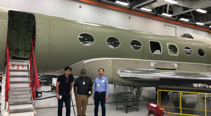 School of Engineering collaboration allows students to work with Gulfstream Aerospace Three men stand in front of an airplane
