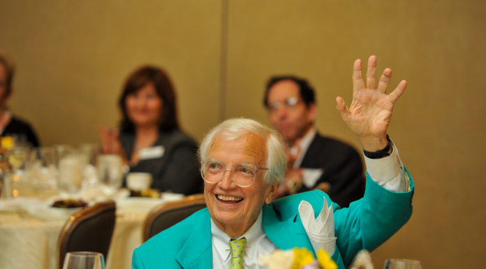 Renowned lawyer and humorist was one of Mercer’s ‘most loyal sons’ | Mercer Legends bob steed sits at a table decorated for a luncheon. he looks up and is waving his hand smiling.